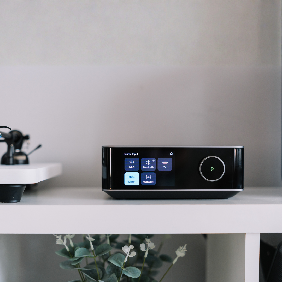 WiiM Amp Ultra connected to bookshelf speakers in living room setup